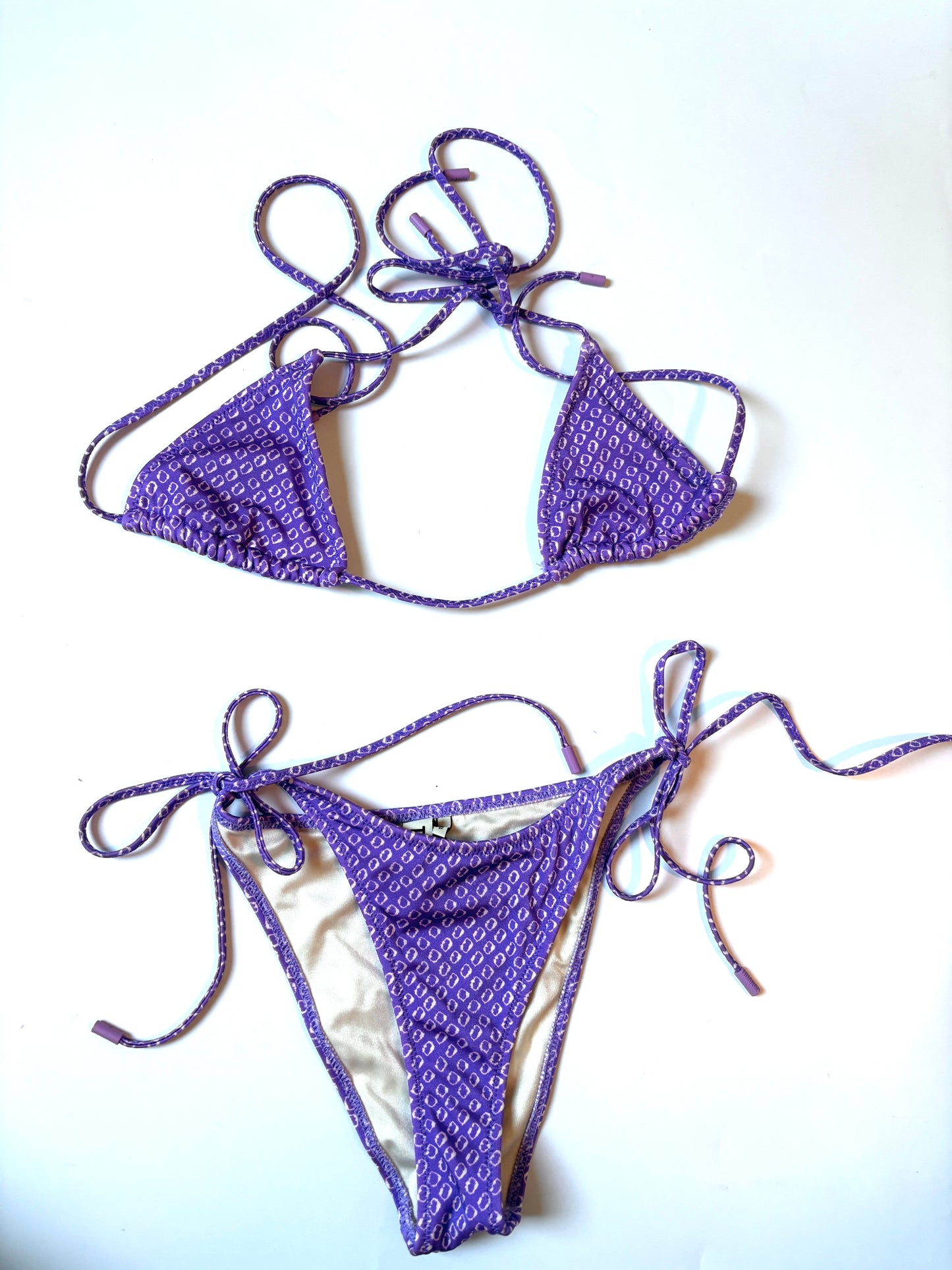 This Triangl Vinca Haze bikini set features a purple and white geometric print and adjustable string ties.