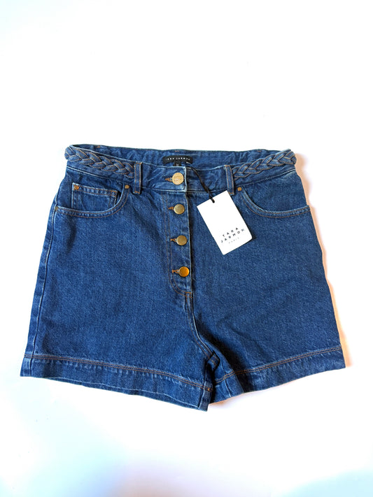 Tara Jarmon Pola shorts. A pair of blue denim shorts with a button fly, braided waistband, and a white paper tag attached, laid flat on a white background.